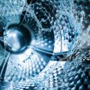 A closeup of an inside of a washing machine with water swirling around the base.